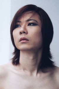 Close-up portrait of beautiful young woman over white background