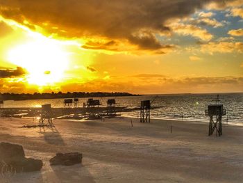 Scenic view of beach against sky during sunset