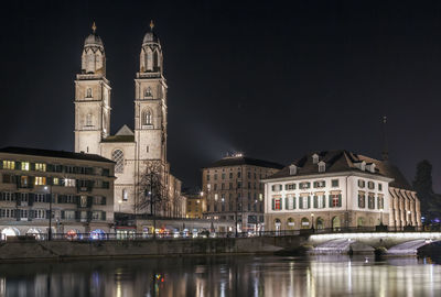 Reflection of illuminated buildings in city at night