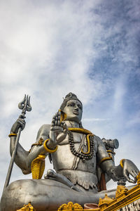 Low angle view of statue against sky