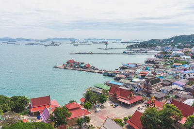 High angle view of townscape by sea against sky