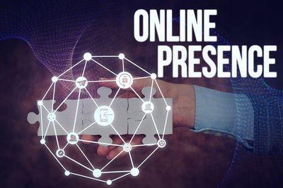 Digital composite image of hand holding illuminated text