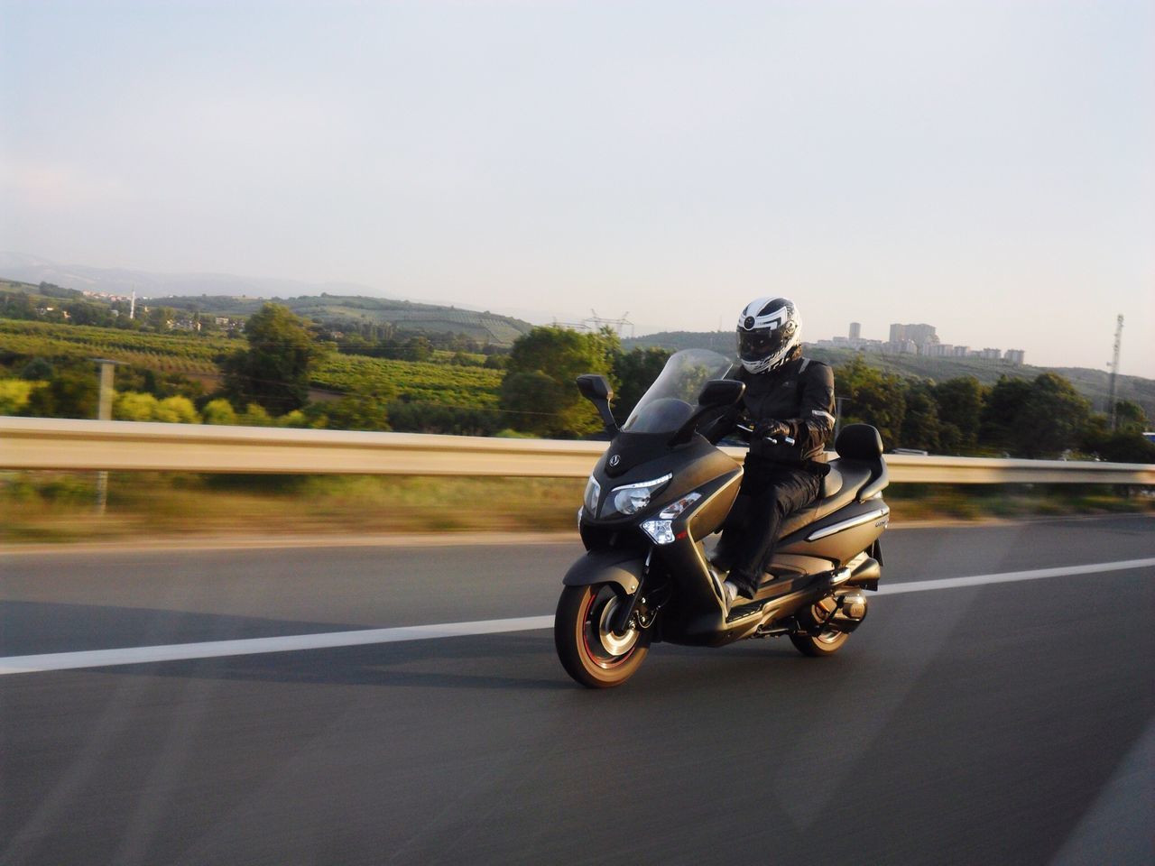 transportation, land vehicle, mode of transport, road, bicycle, riding, street, car, road marking, motorcycle, cycling, on the move, clear sky, travel, one person, motion, copy space, sky, day, stationary