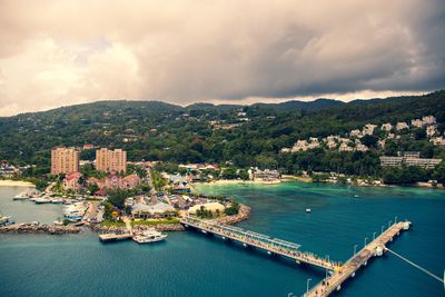 An aerial view of a city view along a beach against the sky. 