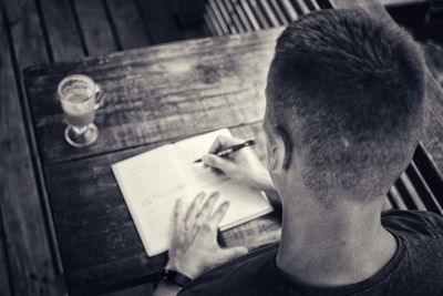 Close-up of man sitting on table