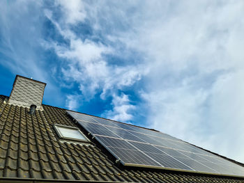 Solar panels producing clean energy on a roof of a residential house