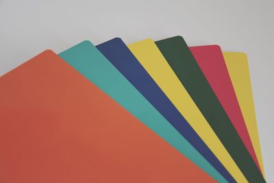 Low angle view of multi colored pencils against white background