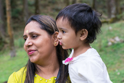 Portrait of mother and daughter outdoors