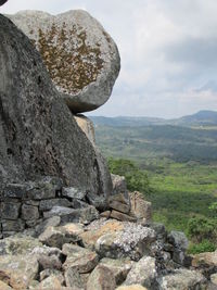Scenic view of rocks on landscape against sky