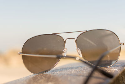 Close-up of sunglasses against clear sky