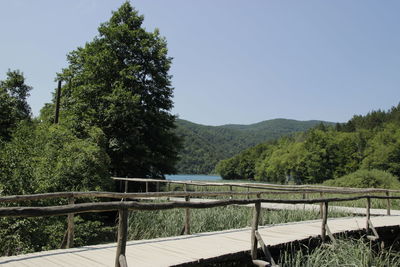Scenic view of river and mountains against clear sky