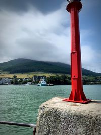 Lifeguard hut on sea against mountain range