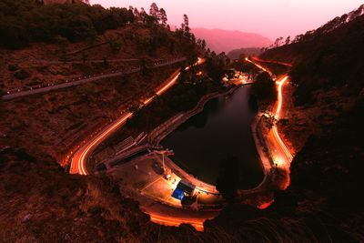 High angle view of illuminated road against sky at night