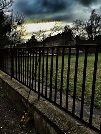 View of fence against cloudy sky