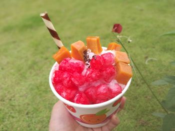 Close-up of hand holding ice cream