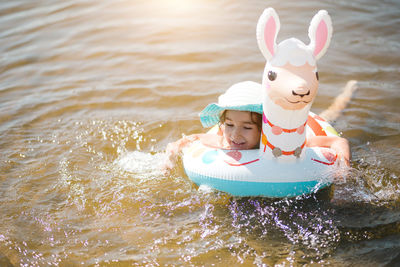 Smiling girl swimming in lake