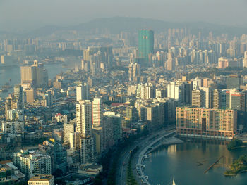 High angle view of city and river during foggy weather