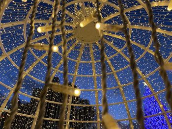 Low angle view of illuminated chandelier hanging in building