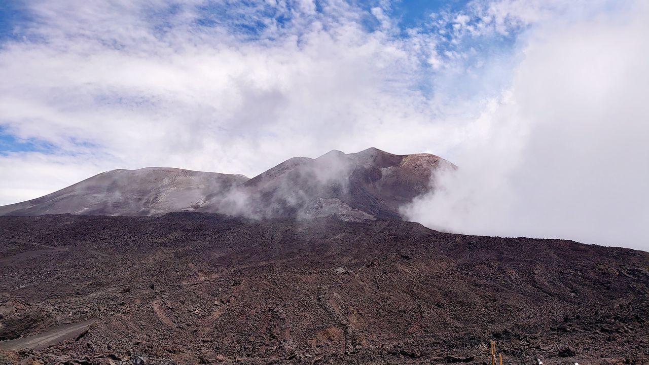 mountain, sky, beauty in nature, scenics - nature, cloud - sky, landscape, non-urban scene, environment, geology, smoke - physical structure, physical geography, tranquil scene, volcano, tranquility, land, nature, no people, day, volcanic landscape, erupting, emitting, outdoors, power in nature, volcanic crater, arid climate, formation, climate