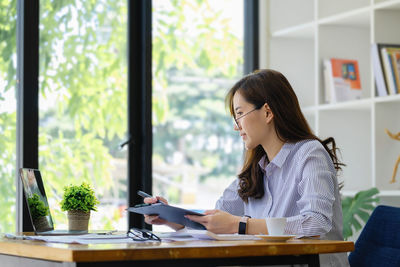 Young woman using laptop at home