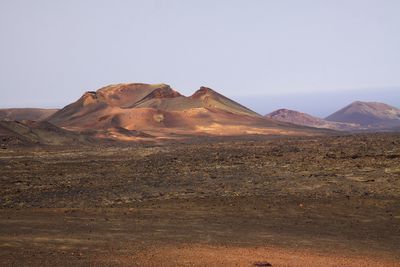 Scenic view of arid landscape against clear sky