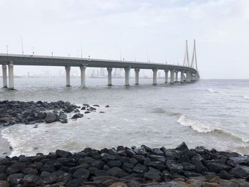 Bridge over sea against sky