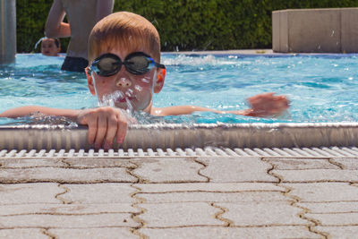 Portrait of boy swimming in pool