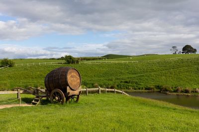 Hay bales on field against sky