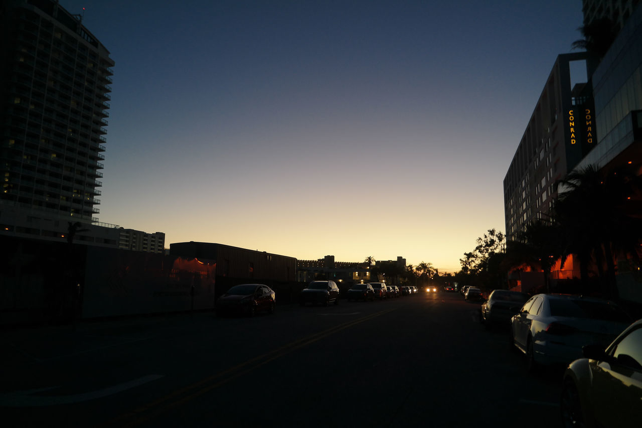 CARS ON ROAD AT DUSK