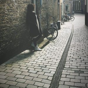 Shadow of woman on bicycle on footpath