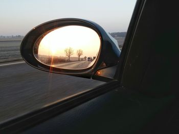 Reflection of car on side-view mirror