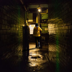 Rear view of man walking in subway