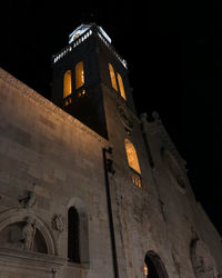 Low angle view of illuminated building against sky at night