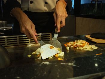 Midsection of man preparing food in kitchen