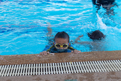 High angle view of boy swimming in pool