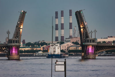 Bascule bridge over river against buildings in city