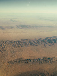 Aerial view of sand dunes in desert against sky