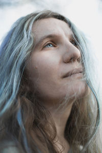 Close up authentic woman with gray hair looking up into sky portrait picture