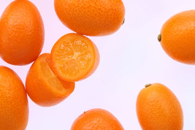 Close-up of orange fruits against white background