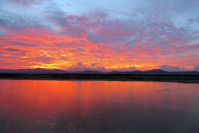 Scenic view of lake against orange sky