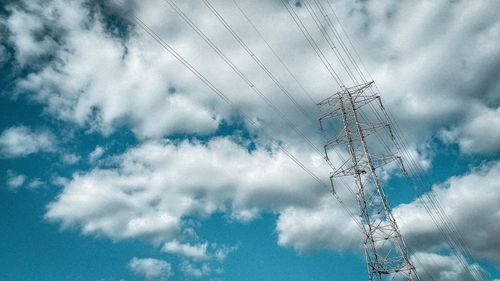 Low angle view of electricity pylon against sky