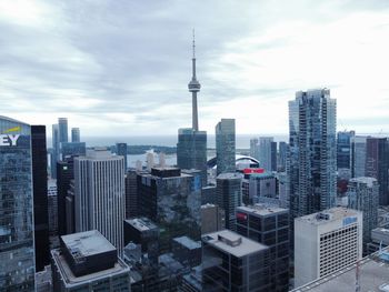 Modern buildings in city against cloudy sky