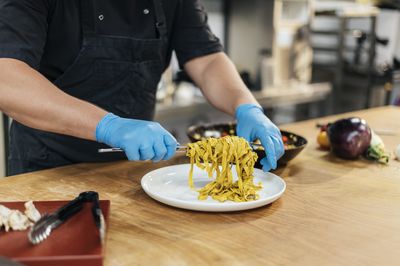 Midsection of man preparing food on table