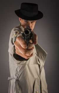 Portrait of man shooting with handgun