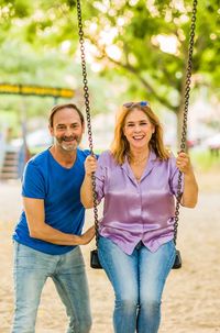 Rear view of woman sitting on swing