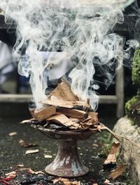 Close-up of smoke emitting from wood