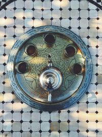 Overhead view of tea pot and cups on tray