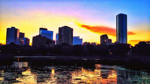 Skyscrapers in city at sunset