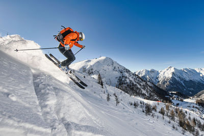 Low angle view of man skiing on snowcapped mountain