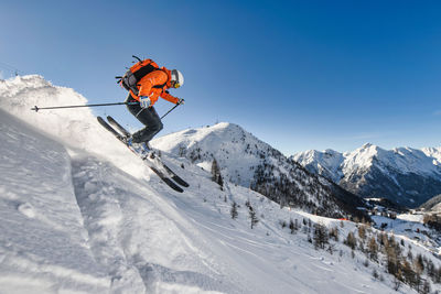 Off-piste skier near a ski resort in the italian alps